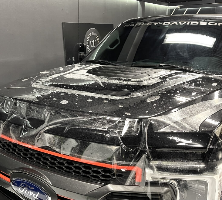 Process of ultimate fusion XPEL in gloss paint protection film being installed on a 2022 Ford F250 Harley Davidson