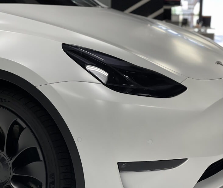 Smoked headlights with XPEL XR plus on 2022 Tesla Model Y. Stealth paint protection film xpel