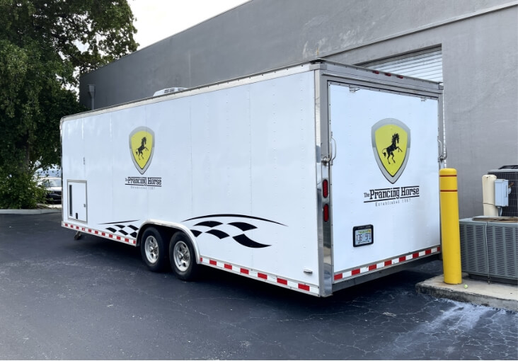Full wrap for trailer using 3m 2080 gloss white vinyl. Custom decals and logos in reflective vinyl. Racing flags die cut in 3m gloss black